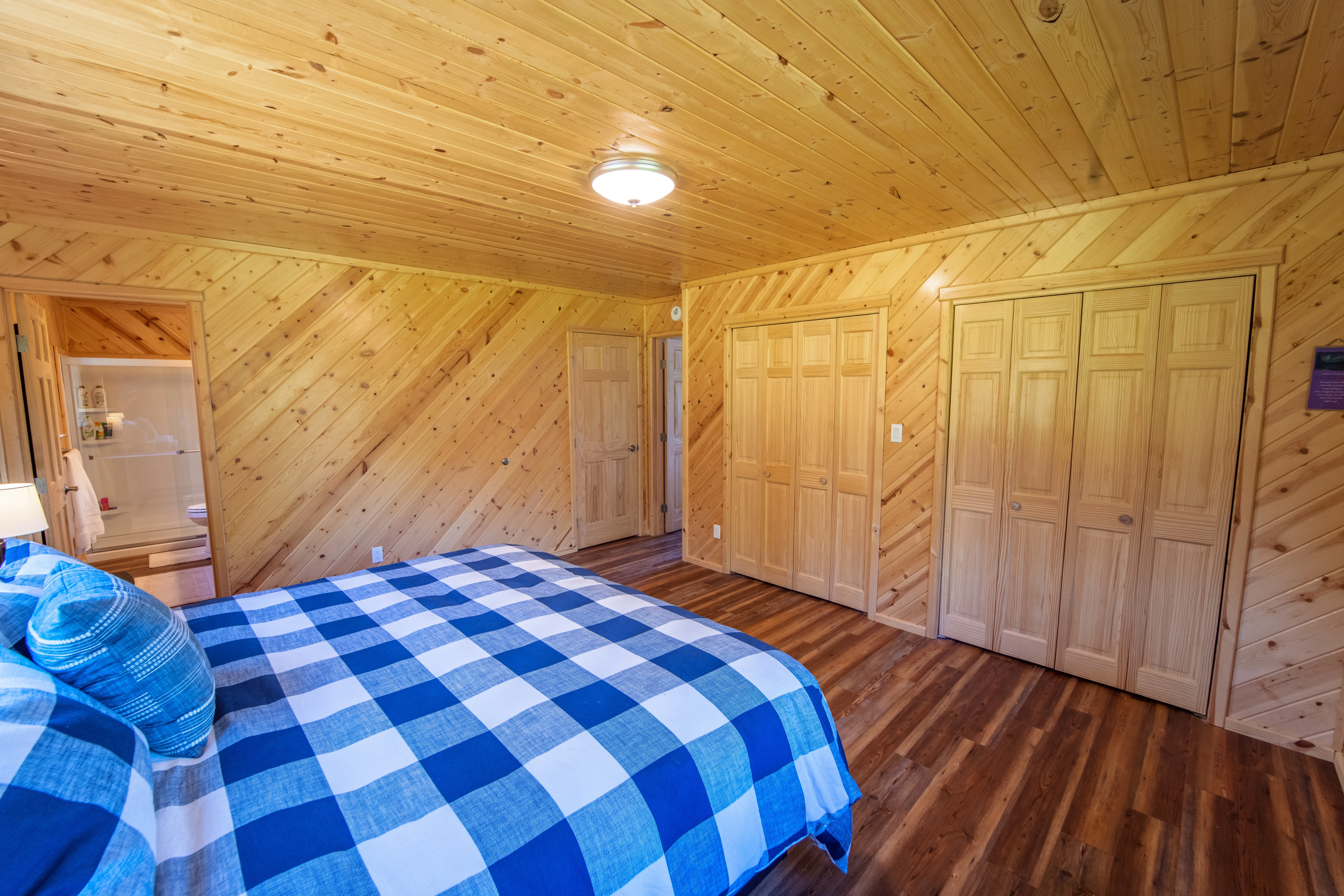 Comfortable master suite with wood paneling.